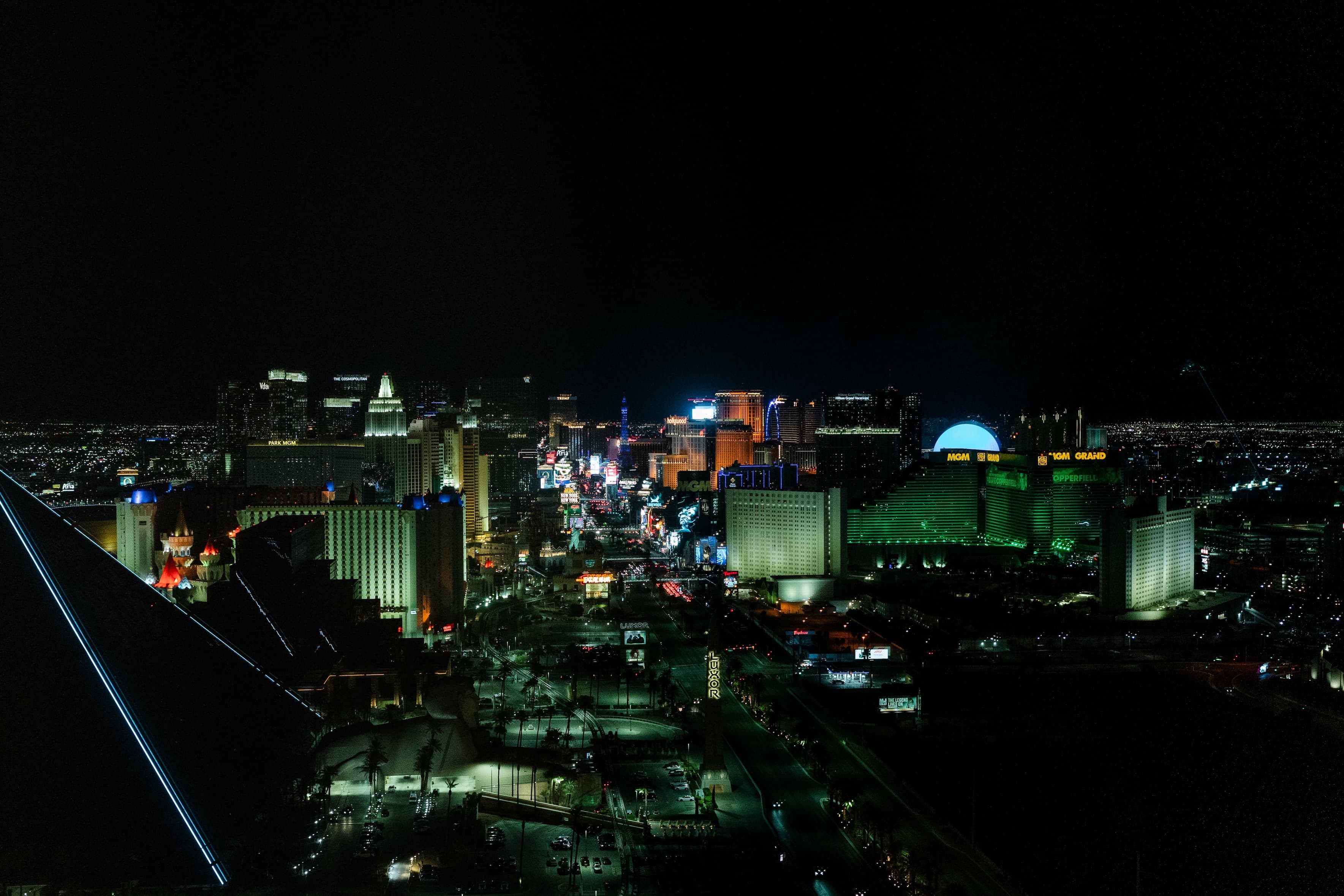 A nighttime view of the Las Vegas Strip, illuminated by the lights of famous hotels and casinos, with a clear view of the city's vibrant life and attractions.